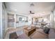 Open concept living area with modern furnishings, a ceiling fan and an open flow to the kitchen at 12239 W Caraveo Pl, Peoria, AZ 85383