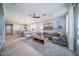 An open-concept living room seamlessly connects to dining, creating an inviting space with ample natural light at 12239 W Caraveo Pl, Peoria, AZ 85383