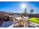 Outdoor kitchen and dining area features a built-in grill and ample seating for entertaining guests at 12239 W Caraveo Pl, Peoria, AZ 85383
