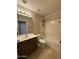 Standard bathroom with white fixtures and warm toned tile flooring at 12547 W Pasadena Ave, Litchfield Park, AZ 85340