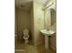 Half bath includes a pedestal sink, and tiled floors at 12547 W Pasadena Ave, Litchfield Park, AZ 85340