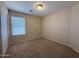 Bedroom featuring a closet, window with blinds, and neutral carpeting at 12547 W Pasadena Ave, Litchfield Park, AZ 85340