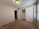 A standard bedroom with carpet, a light, and a closet at 12547 W Pasadena Ave, Litchfield Park, AZ 85340