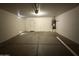 Spacious garage with overhead lighting and room for storage at 12547 W Pasadena Ave, Litchfield Park, AZ 85340