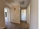 Hallway with multiple doorways showing access to various rooms at 12547 W Pasadena Ave, Litchfield Park, AZ 85340