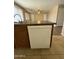 Well-lit kitchen featuring an island with a white dishwasher, cabinets and tile flooring at 12547 W Pasadena Ave, Litchfield Park, AZ 85340