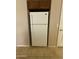 Kitchen featuring a white refrigerator, cabinet and tile flooring at 12547 W Pasadena Ave, Litchfield Park, AZ 85340