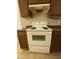 Kitchen with white range and wood cabinets at 12547 W Pasadena Ave, Litchfield Park, AZ 85340