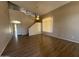 Spacious living room featuring vaulted ceilings, wood floors, and large windows for natural light at 12547 W Pasadena Ave, Litchfield Park, AZ 85340