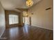 Open-concept living room with wood floors, vaulted ceilings, and natural light, offering a welcoming atmosphere at 12547 W Pasadena Ave, Litchfield Park, AZ 85340