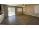 This large living room has laminate floors, access to the backyard, and updated ceiling fan at 12547 W Pasadena Ave, Litchfield Park, AZ 85340