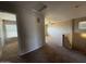 An upstairs loft area with tan carpet, a ceiling fan, and an open floor plan at 12547 W Pasadena Ave, Litchfield Park, AZ 85340
