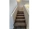 Carpeted staircase with white railings, leading to the upper level at 12547 W Pasadena Ave, Litchfield Park, AZ 85340
