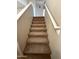 Carpeted staircase with white railing leading to the upper level of the home at 12547 W Pasadena Ave, Litchfield Park, AZ 85340