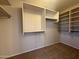 Spacious walk-in closet with shelving and rods for ample storage at 12547 W Pasadena Ave, Litchfield Park, AZ 85340