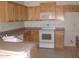 Kitchen featuring wood cabinets, white appliances and tile floor at 1412 E Oakland St, Gilbert, AZ 85295