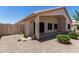 Charming backyard featuring a covered patio, privacy fence, and low-maintenance desert landscaping at 14672 W Whitton Ave, Goodyear, AZ 85395