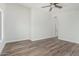 A spacious bedroom with wood floors and a ceiling fan at 14672 W Whitton Ave, Goodyear, AZ 85395