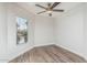 A corner bedroom with wood floors and a window at 14672 W Whitton Ave, Goodyear, AZ 85395