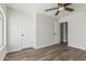 The bedroom with wood floor features a ceiling fan and neutral colored walls at 14672 W Whitton Ave, Goodyear, AZ 85395