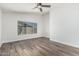 A bright, airy bedroom featuring wood floors, and white trim at 14672 W Whitton Ave, Goodyear, AZ 85395