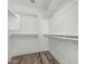 A walk-in closet featuring wood floors and shelving at 14672 W Whitton Ave, Goodyear, AZ 85395