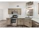 Bright kitchen with stainless steel appliances, marble countertops and ample cabinets at 14672 W Whitton Ave, Goodyear, AZ 85395