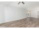 Bright living room with wood floors and a ceiling fan providing a comfortable, airy feel at 14672 W Whitton Ave, Goodyear, AZ 85395