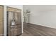 Bright living room and kitchen with stainless steel fridge and wood floors at 14672 W Whitton Ave, Goodyear, AZ 85395