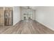 Bright living room with stainless steel fridge, wood floors and backyard slider door at 14672 W Whitton Ave, Goodyear, AZ 85395