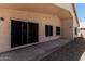 The covered patio looks out to a gravel backyard with lush green grass at 14672 W Whitton Ave, Goodyear, AZ 85395