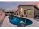 Backyard with a sparkling pool, lounge area, a basketball hoop, and lush landscaping at 15515 N 165Th Ave, Surprise, AZ 85388