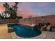 Backyard featuring a sparkling pool with rock features and a basketball hoop at 15515 N 165Th Ave, Surprise, AZ 85388