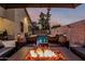 Backyard features a pool, comfortable seating, ambient lighting, and mature landscaping for outdoor enjoyment at 15515 N 165Th Ave, Surprise, AZ 85388