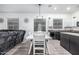 Bright dining area featuring a farmhouse-style table, chandelier, and open floor plan to the kitchen with a breakfast bar at 15515 N 165Th Ave, Surprise, AZ 85388