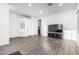 Open living space showcases wood floors, a large TV, and smooth transitions into the kitchen and dining areas at 15515 N 165Th Ave, Surprise, AZ 85388