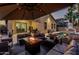 Outdoor patio featuring a fire pit, lounge furniture, umbrella and a view of the pool at 15515 N 165Th Ave, Surprise, AZ 85388