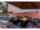 Outdoor patio featuring a fire pit, lounge furniture, umbrella and a view of the pool at 15515 N 165Th Ave, Surprise, AZ 85388
