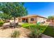 Spacious backyard features grass, pavers, mature landscaping, outdoor seating, and a playset at 16860 W Soft Wind Dr, Surprise, AZ 85387