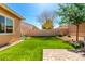 Backyard with artificial grass, string lights, a playset, and paved patio at 16860 W Soft Wind Dr, Surprise, AZ 85387
