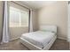 Bedroom featuring neutral walls, carpeted floors, and a large window at 16860 W Soft Wind Dr, Surprise, AZ 85387