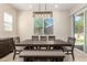 Bright dining area features contemporary lighting, a large window, and a stylish dark wood table with seating at 16860 W Soft Wind Dr, Surprise, AZ 85387