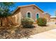 Charming single-story home featuring a desert landscape, tiled roof, and arched windows at 16860 W Soft Wind Dr, Surprise, AZ 85387