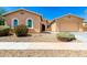 Inviting single-story home showcasing desert landscaping, a two-car garage, and a welcoming entrance at 16860 W Soft Wind Dr, Surprise, AZ 85387