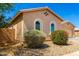 Charming single-story home featuring a desert landscape, tiled roof, and arched windows at 16860 W Soft Wind Dr, Surprise, AZ 85387