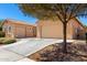 Desert home with a spacious driveway leading to a two-car garage and additional parking at 16860 W Soft Wind Dr, Surprise, AZ 85387