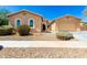 Inviting single-story home showcasing desert landscaping, a two-car garage, and a welcoming entrance at 16860 W Soft Wind Dr, Surprise, AZ 85387