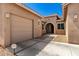 Charming home with a two-car garage and inviting entryway surrounded by desert landscaping at 16860 W Soft Wind Dr, Surprise, AZ 85387