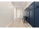 Inviting entryway featuring tile flooring, a bench, and a navy-blue decorative wall panel at 16860 W Soft Wind Dr, Surprise, AZ 85387