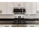 Modern kitchen featuring stainless steel appliances, granite countertops, and subway tile backsplash at 16860 W Soft Wind Dr, Surprise, AZ 85387